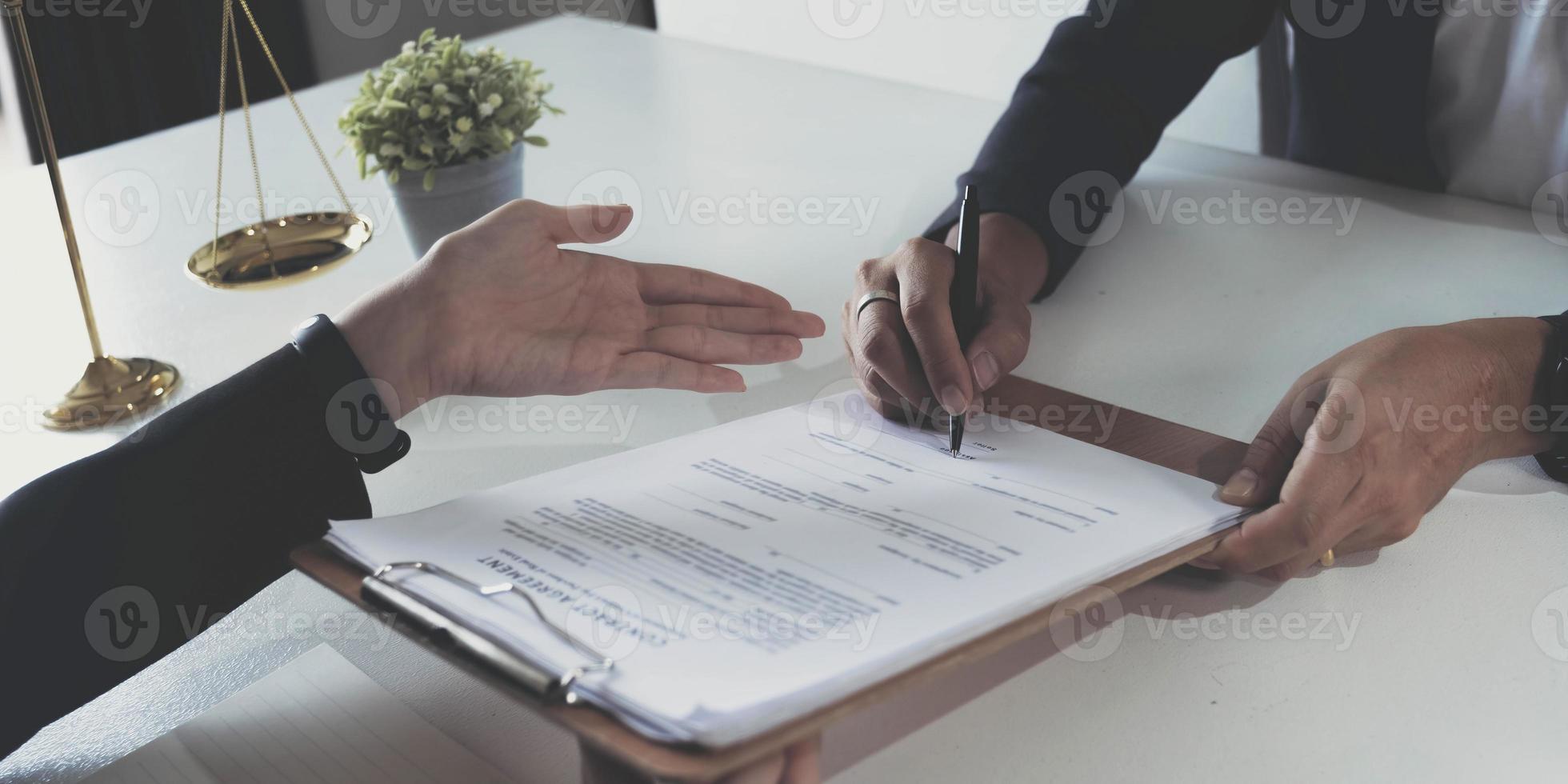 business people and lawyers discussing contract papers sitting at the table. Concepts of law, advice, legal services. photo