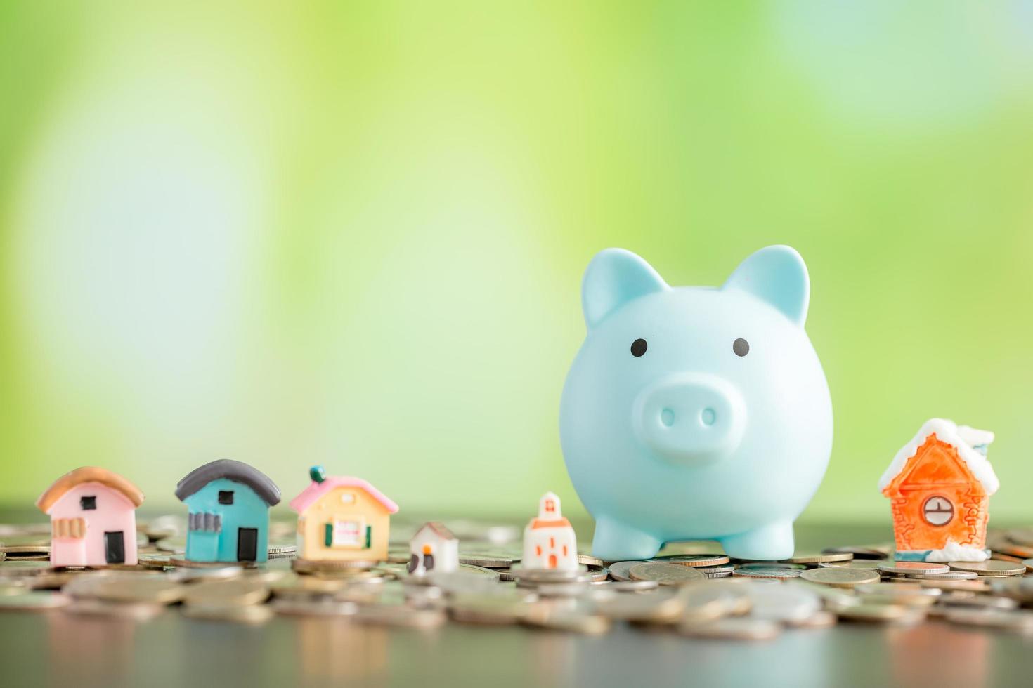 Mini house with piggy bank and coins money photo