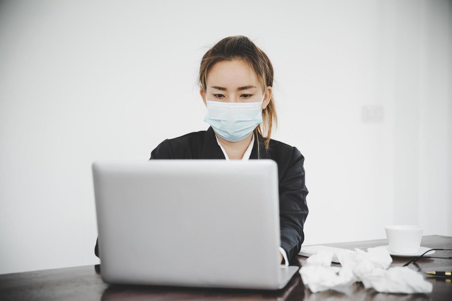 Sick young asian business woman wearing protective face mask photo