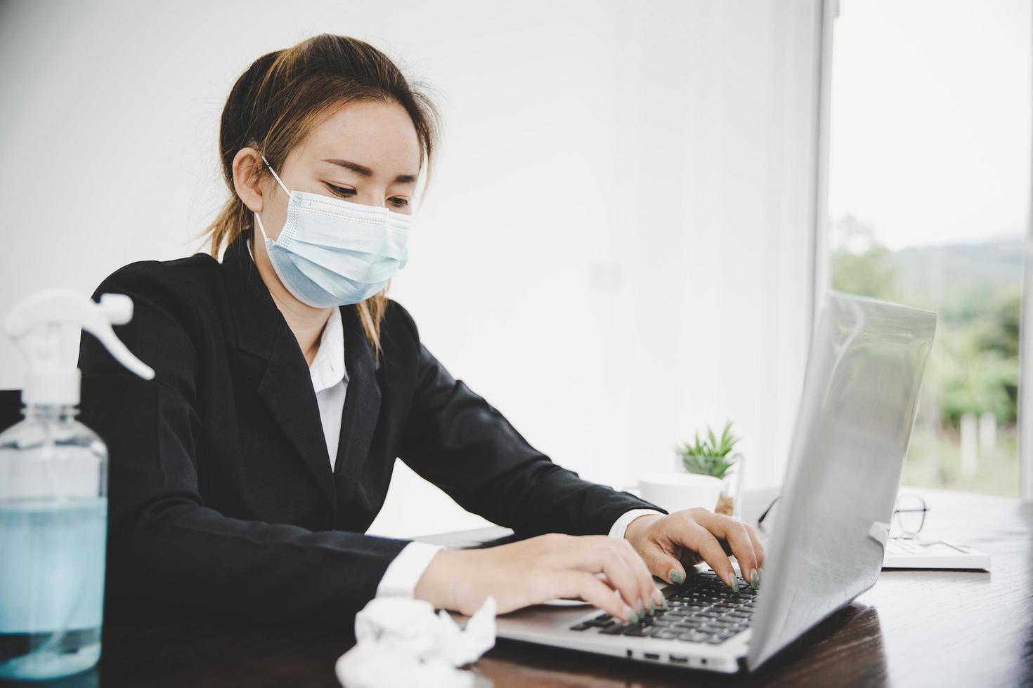 Sick young asian business woman wearing protective face mask photo