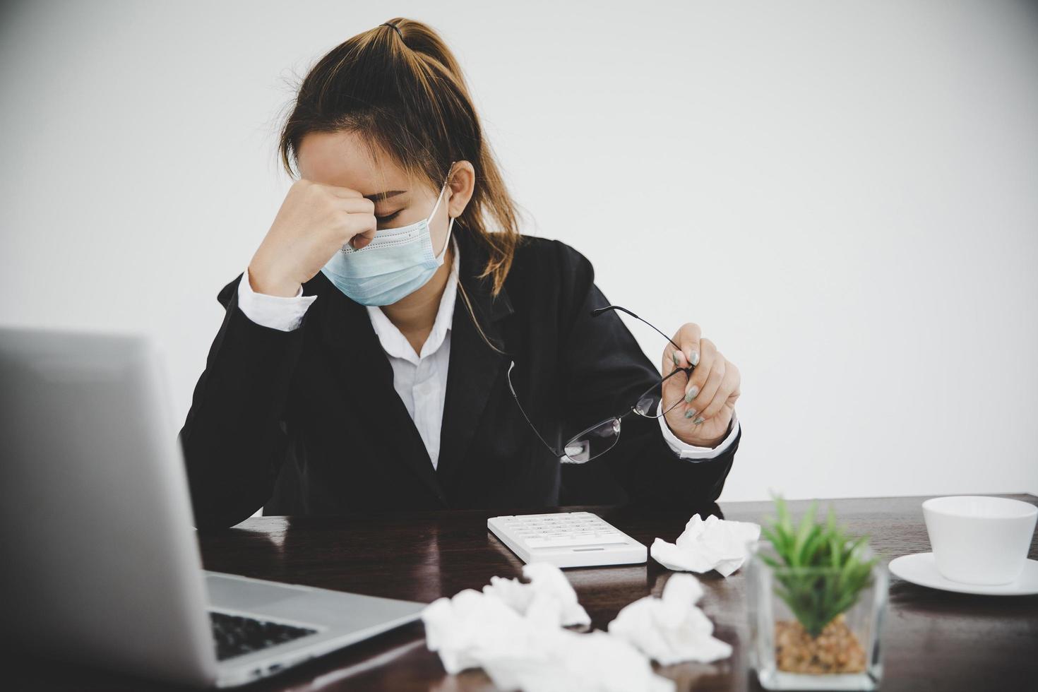 Sick young asian business woman wearing protective face mask photo