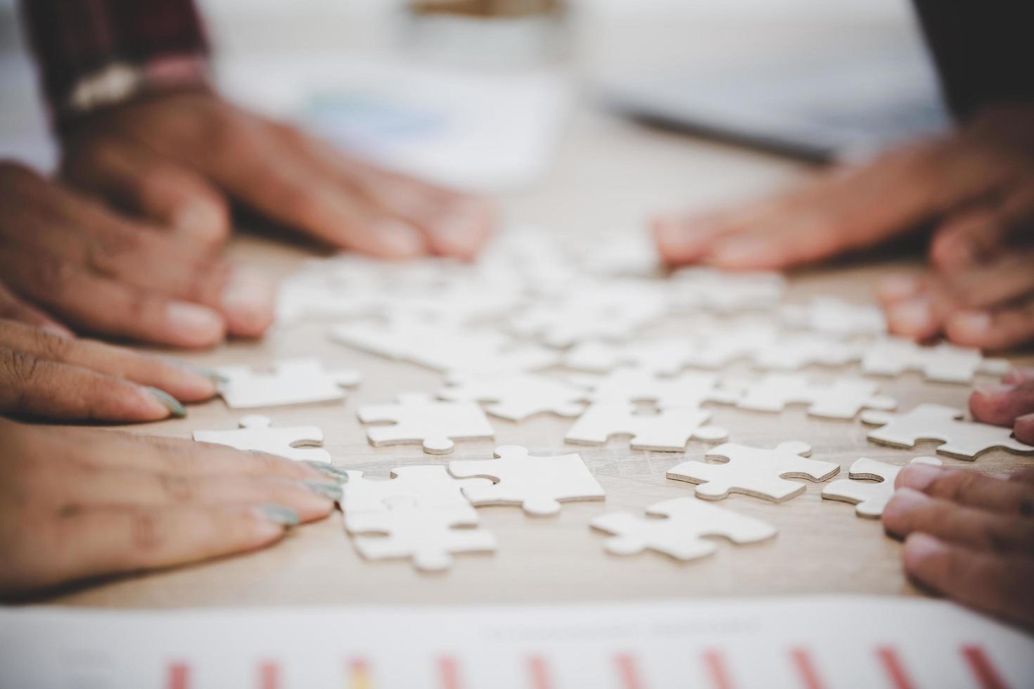 Business people and puzzle on wooden table photo