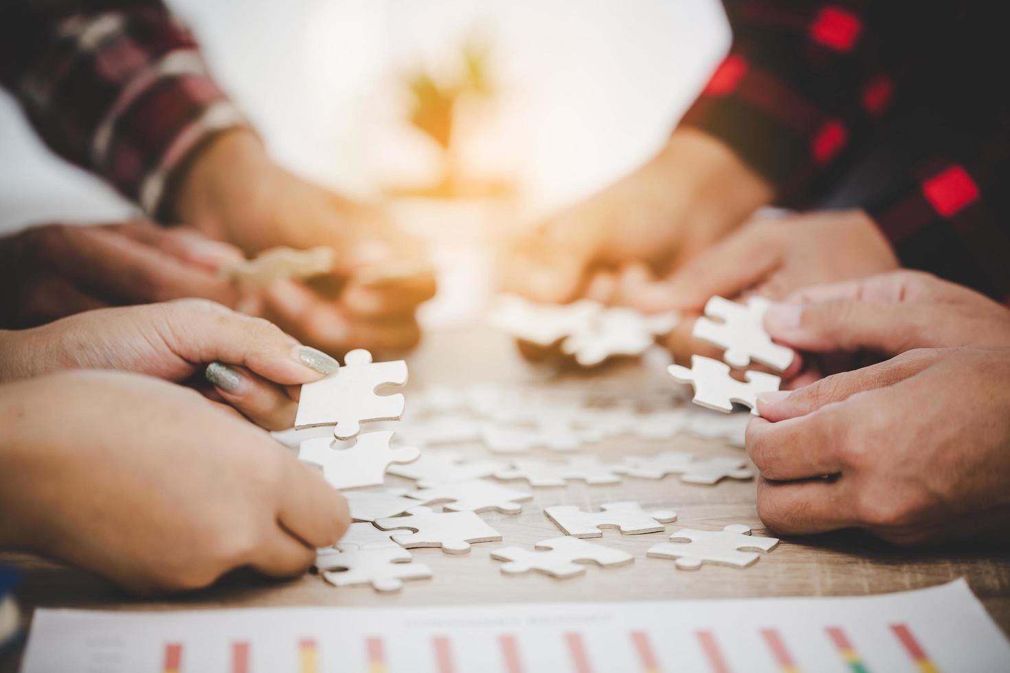 Business people and puzzle on wooden table photo