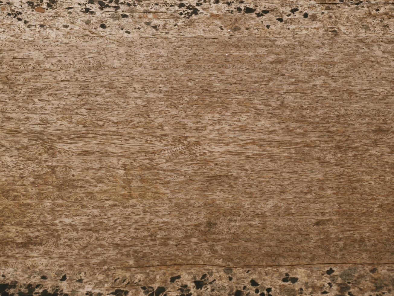 An old wooden plank table with a mottled surface and a pattern. photo