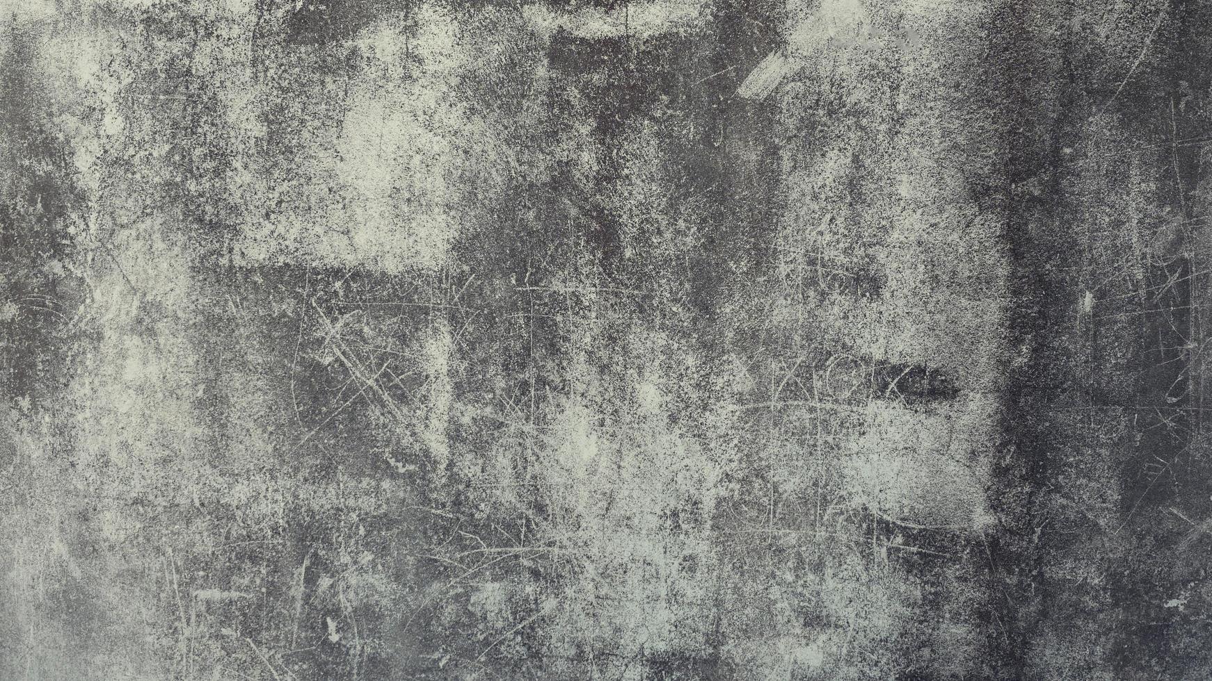 The old cement wall was weathered, the surface was scratched, the surface was scratched and damaged. For a mysterious retro-conservative background. photo