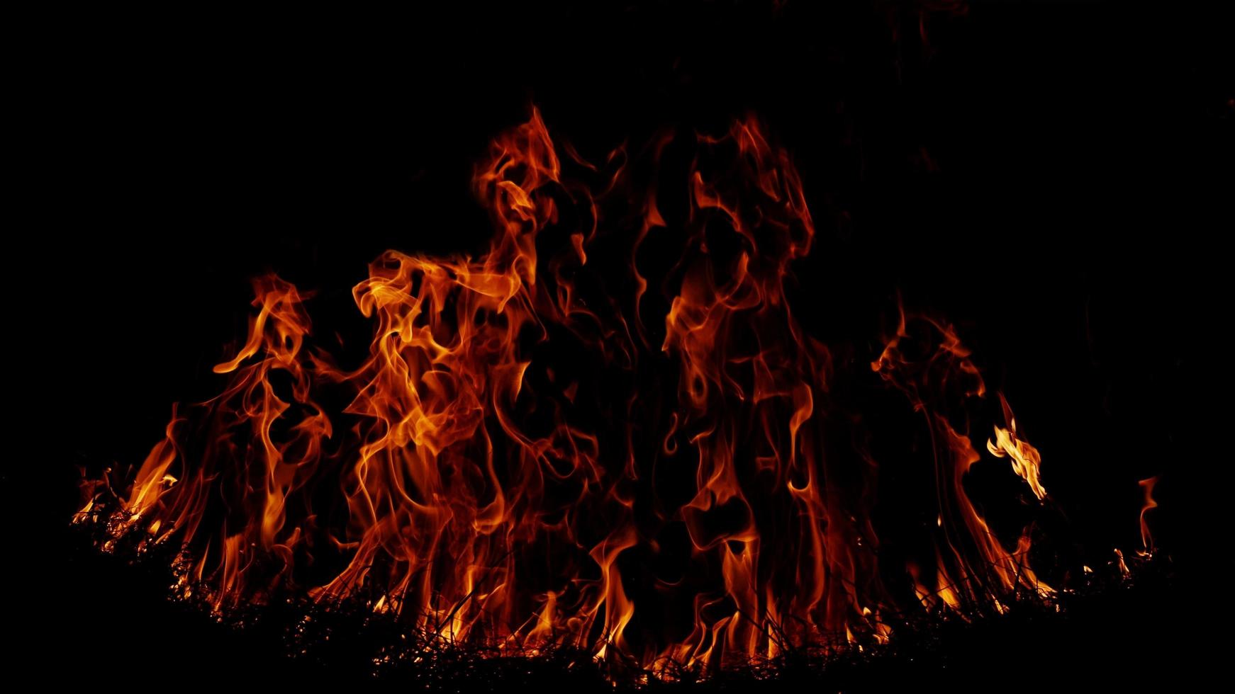 Haystack fires at night in arid areas The ash erupted and the wind was very dangerous. ashes red as hell. photo