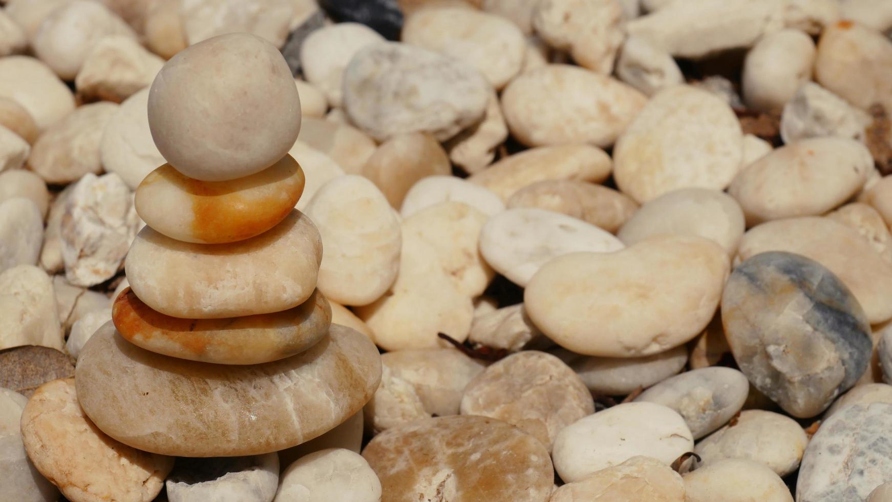 The Balance Stones are stacked as pyramids in a soft natural bokeh background, representing the calm philosophical concept of Jainism's wellness. photo