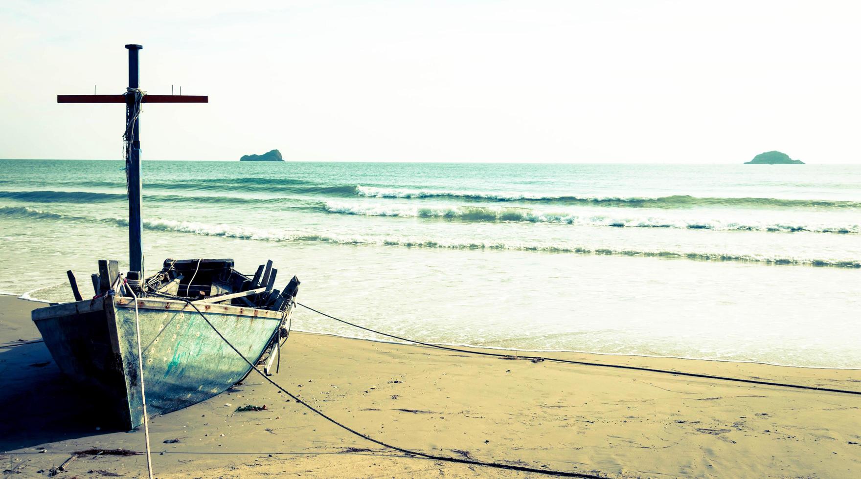 broken boat by sea photo