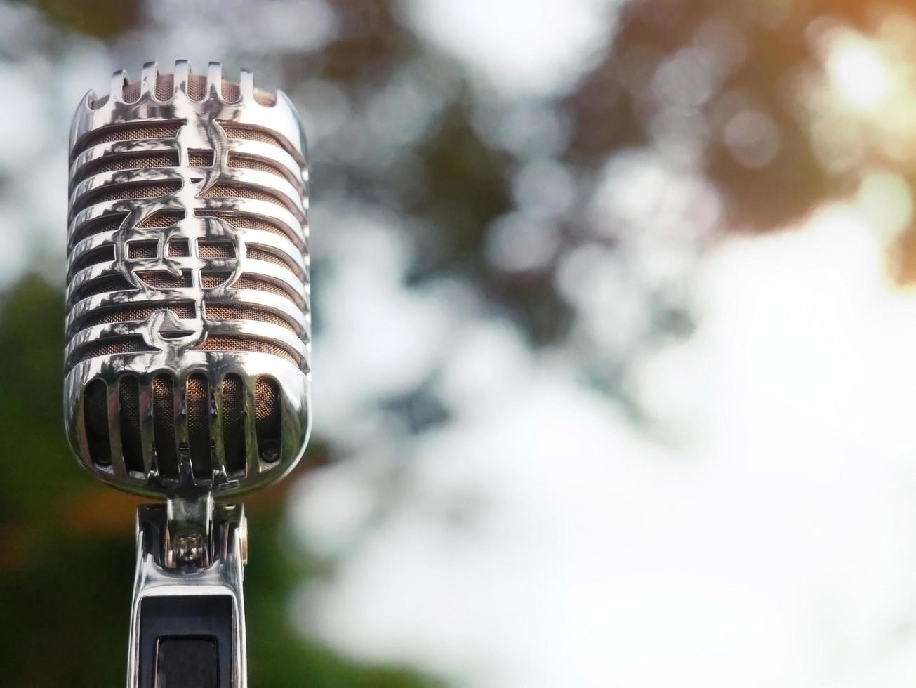 Retro microphone for recording and performing for singers on stage. Bokeh light background can put advertising text. photo