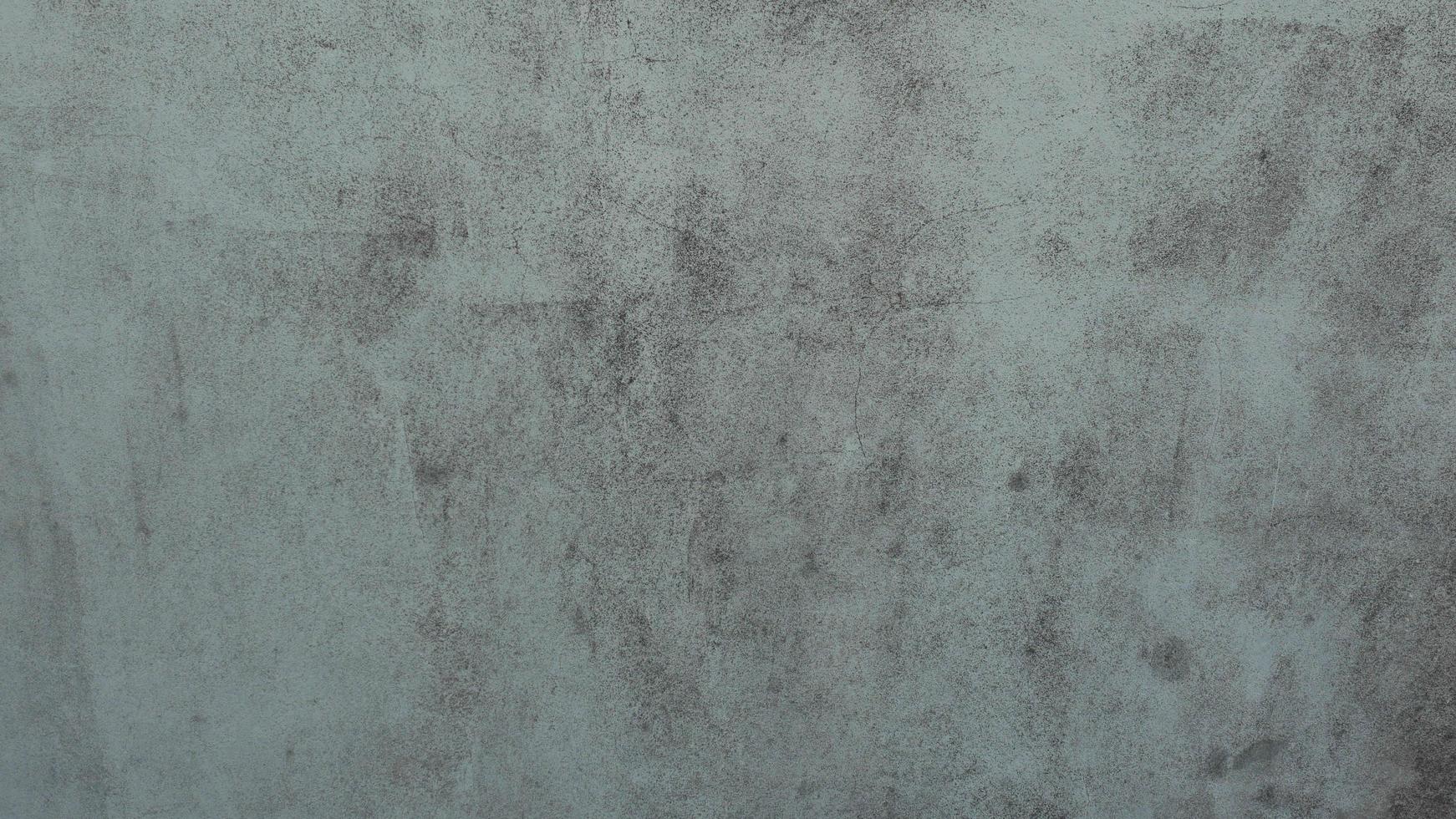 The old cement wall was weathered, the surface was scratched, the surface was scratched and damaged. For a mysterious retro-conservative background. photo