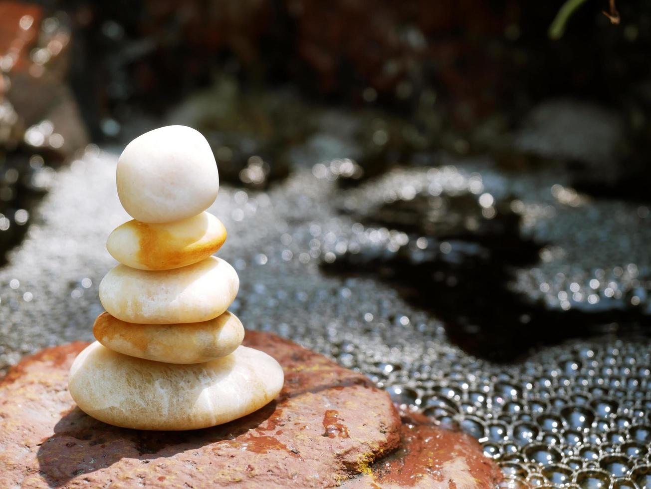 The Balance Stones are stacked as pyramids in a soft natural bokeh background, representing the calm philosophical concept of Jainism's wellness. photo