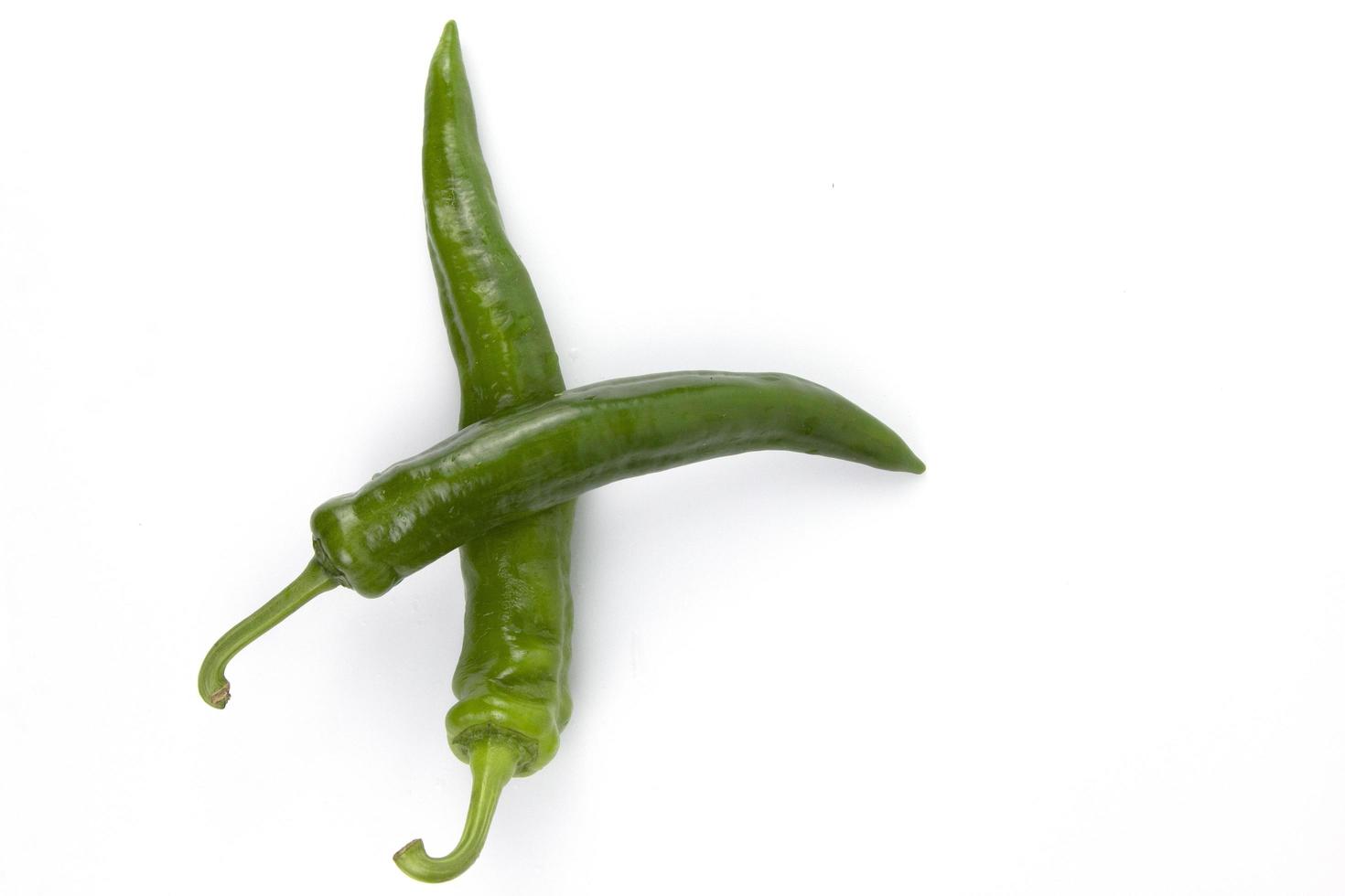 green organic chili isolated on a white background, used for healthy cooking concepts design photo