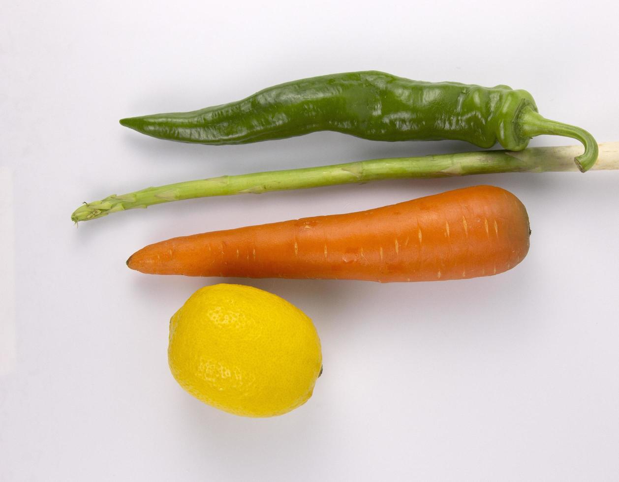 alimentos saludables para cocinar, zanahoria, chile, limón, espárragos aislados en fondo blanco foto