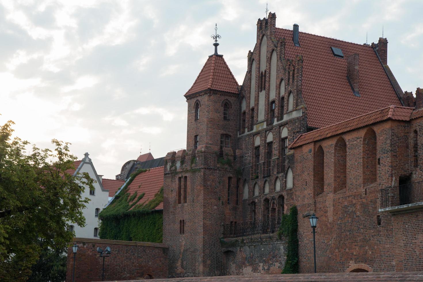 Facade of a beautiful brick building in Torun, Poland photo
