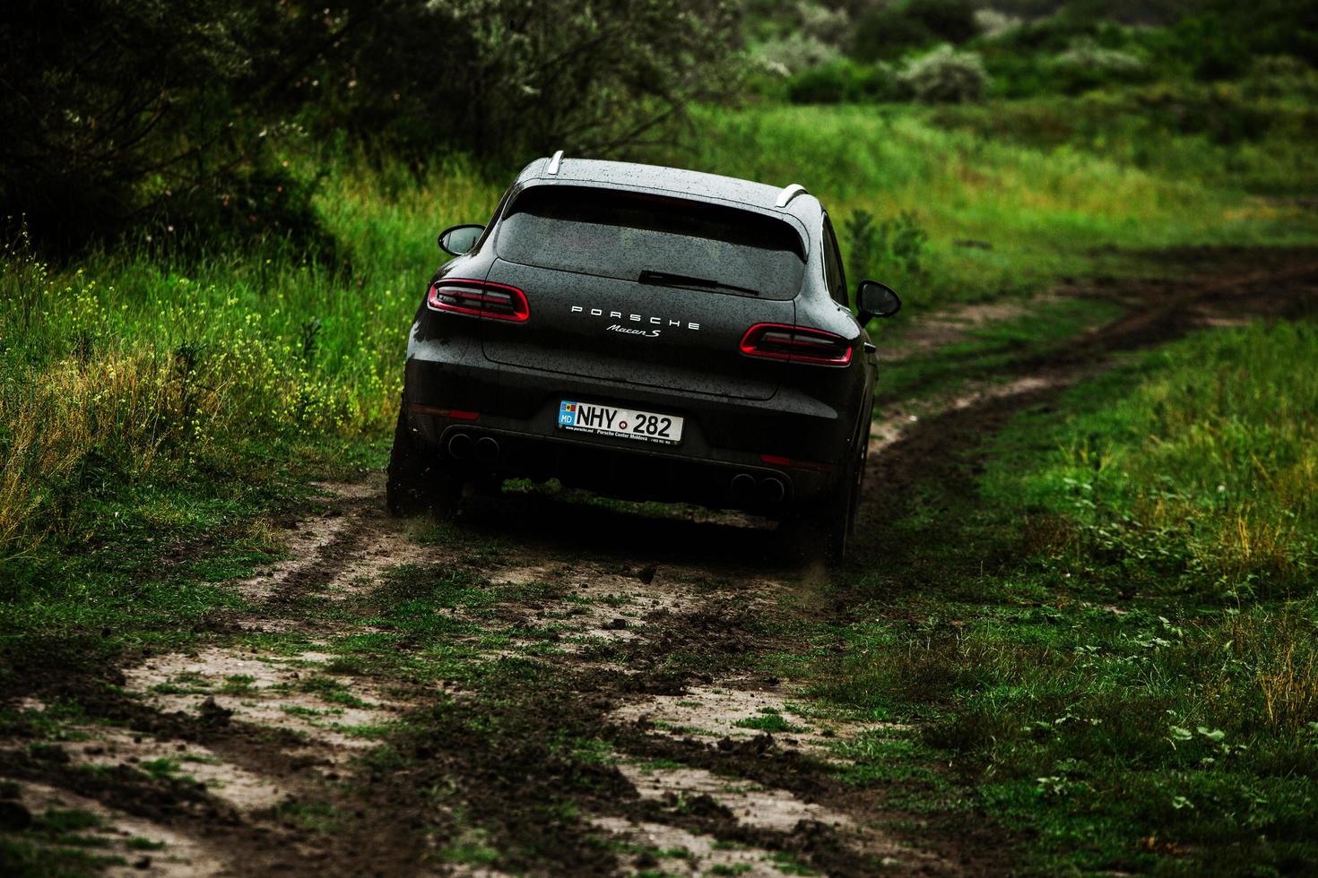 CHISINAU, MOLDOVA - JUNE 17, 2021, Porsche Macan S in off-road racing full of mood on bad road in Moldova. Editorial photo. photo