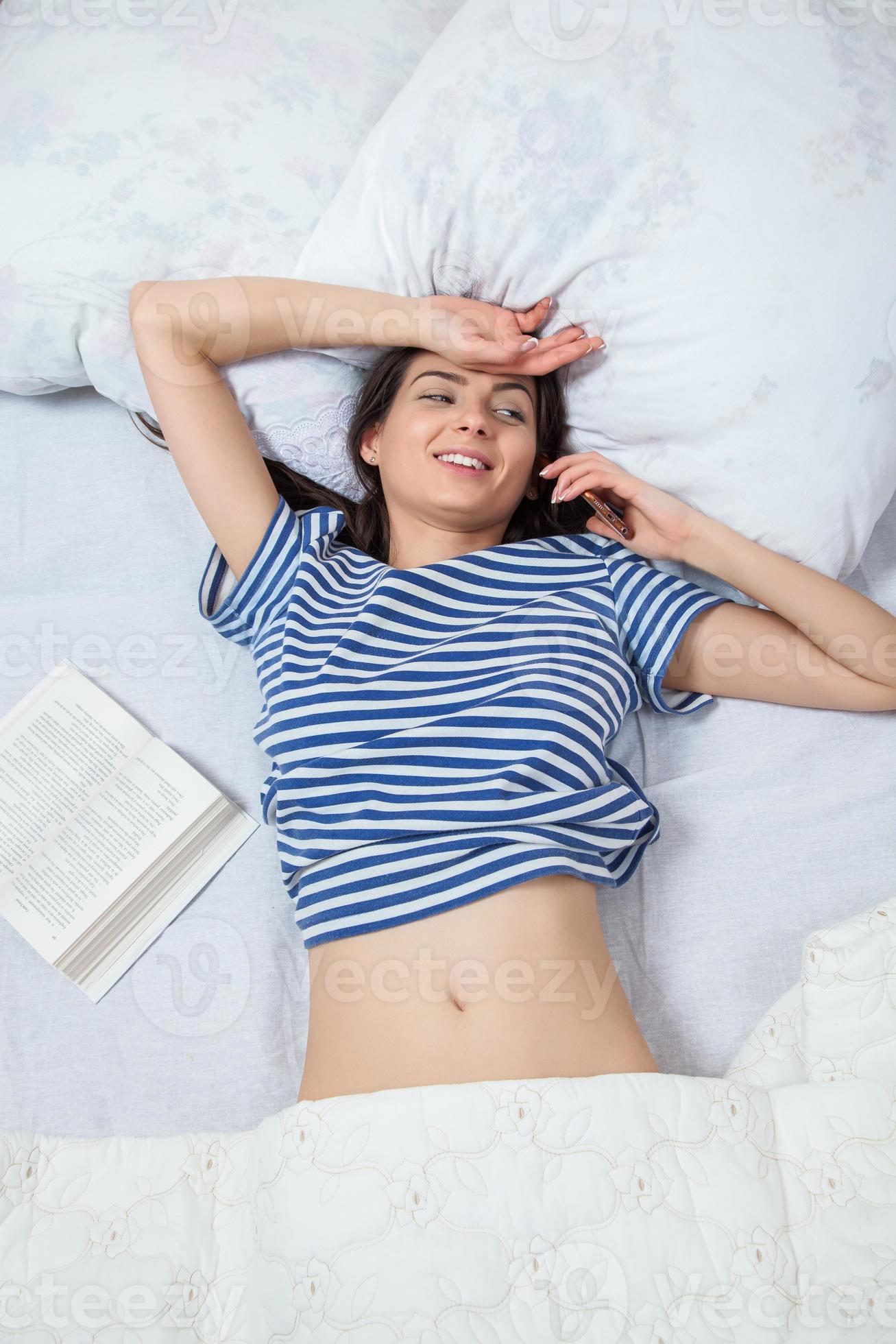 Girl sleeps in a white bed at home. Young woman sleeping in sleepwear