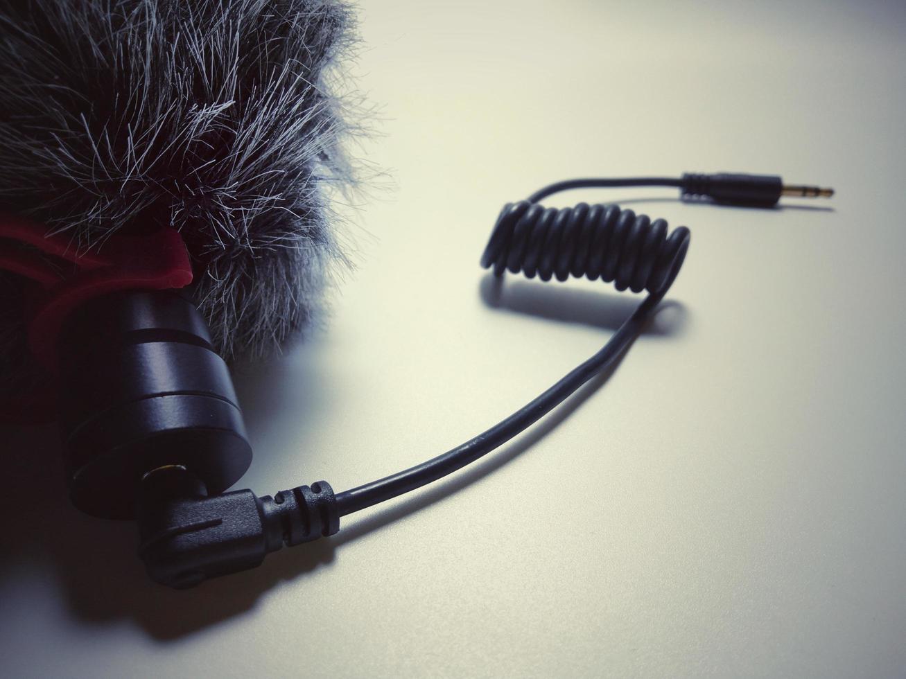 black microphone with gray hair used to record sound blur background vintage style photo