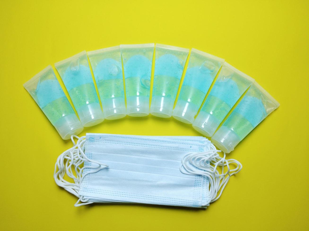 Alcohol gel mask tube blue yellow background, concept, prevention of epidemic covid 19 photo