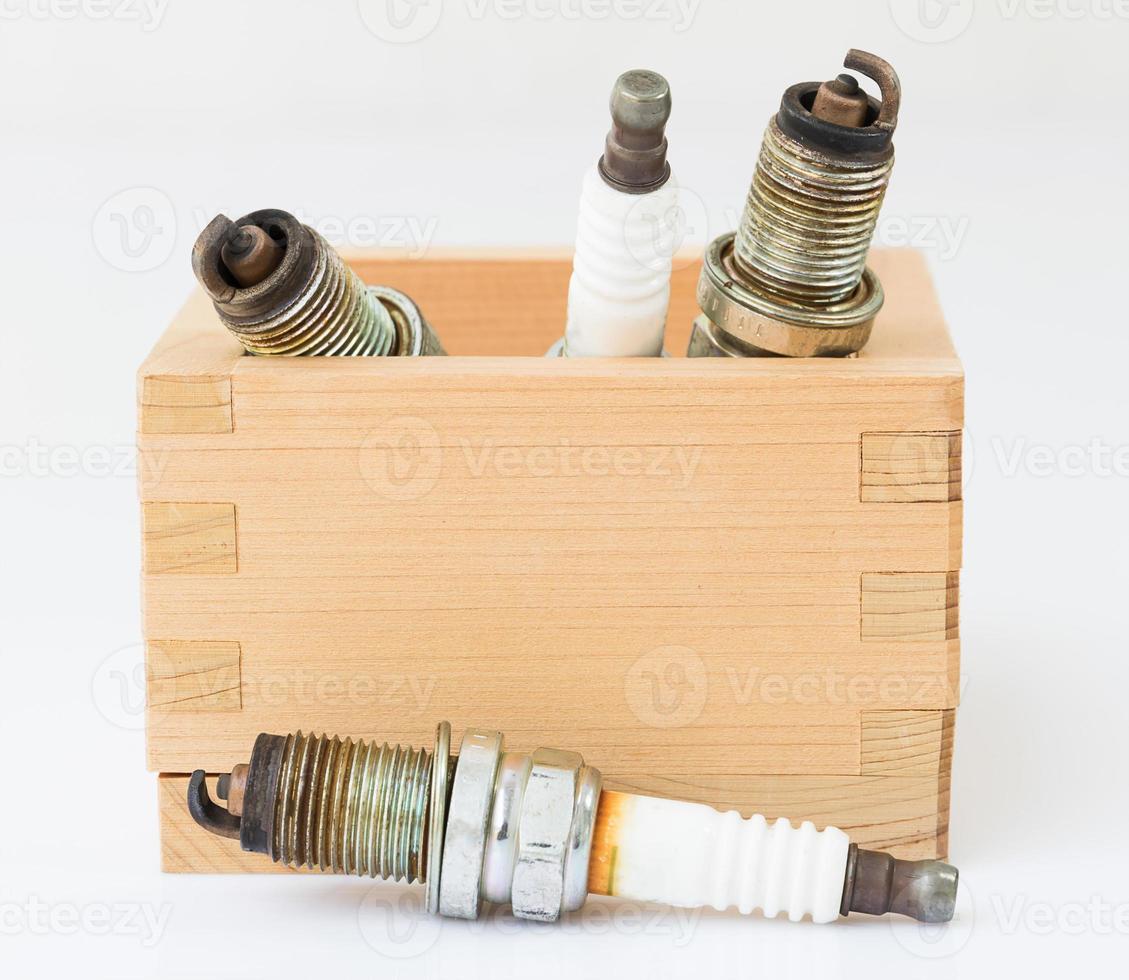 Spark plug in wood box photo