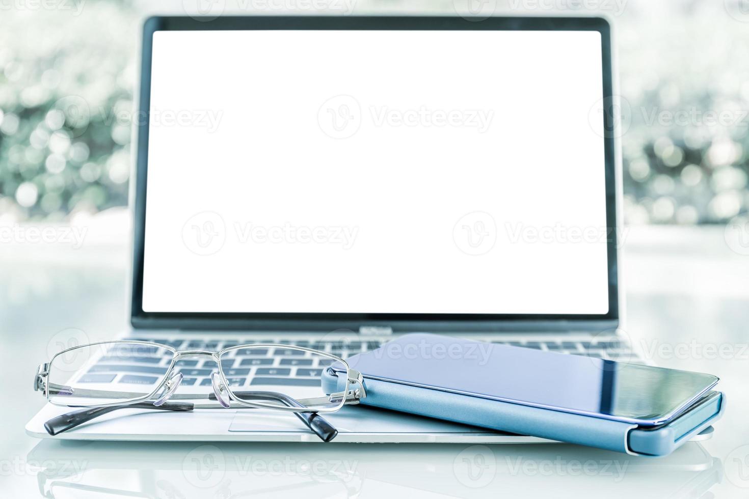 Cellphone and eye glasses on table photo