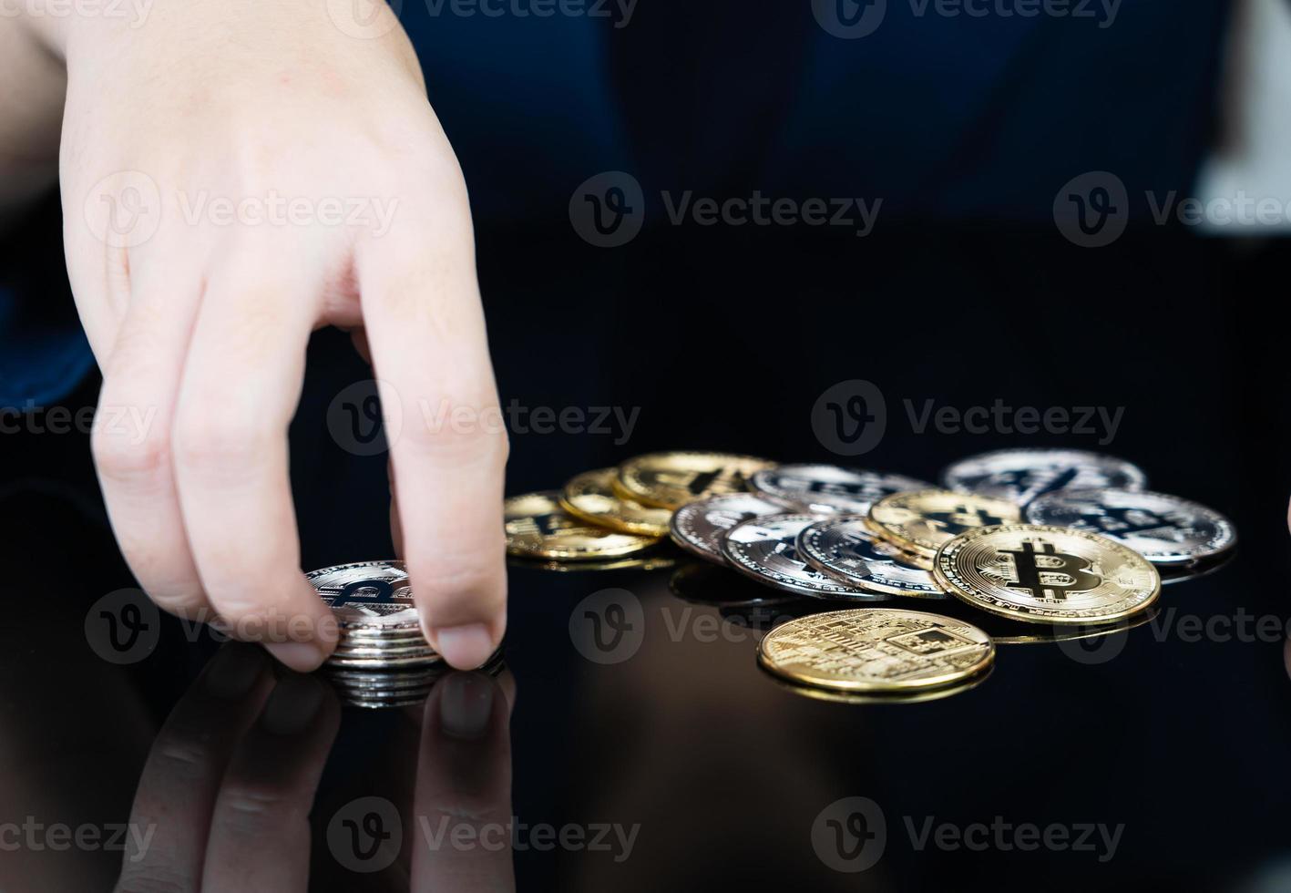 Woman holding some pieces of golden Bitcoin token photo