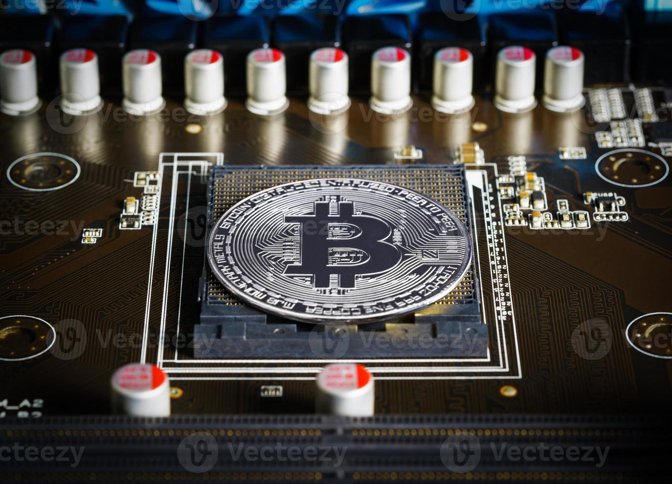 Cryptocurrency bitcoin silver coins on circuit board photo