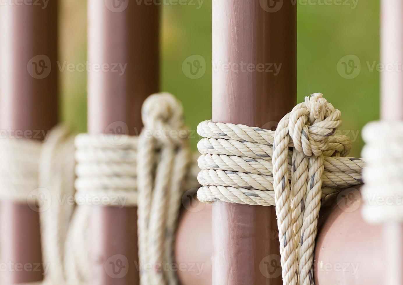 Rope knot around a metal fence photo