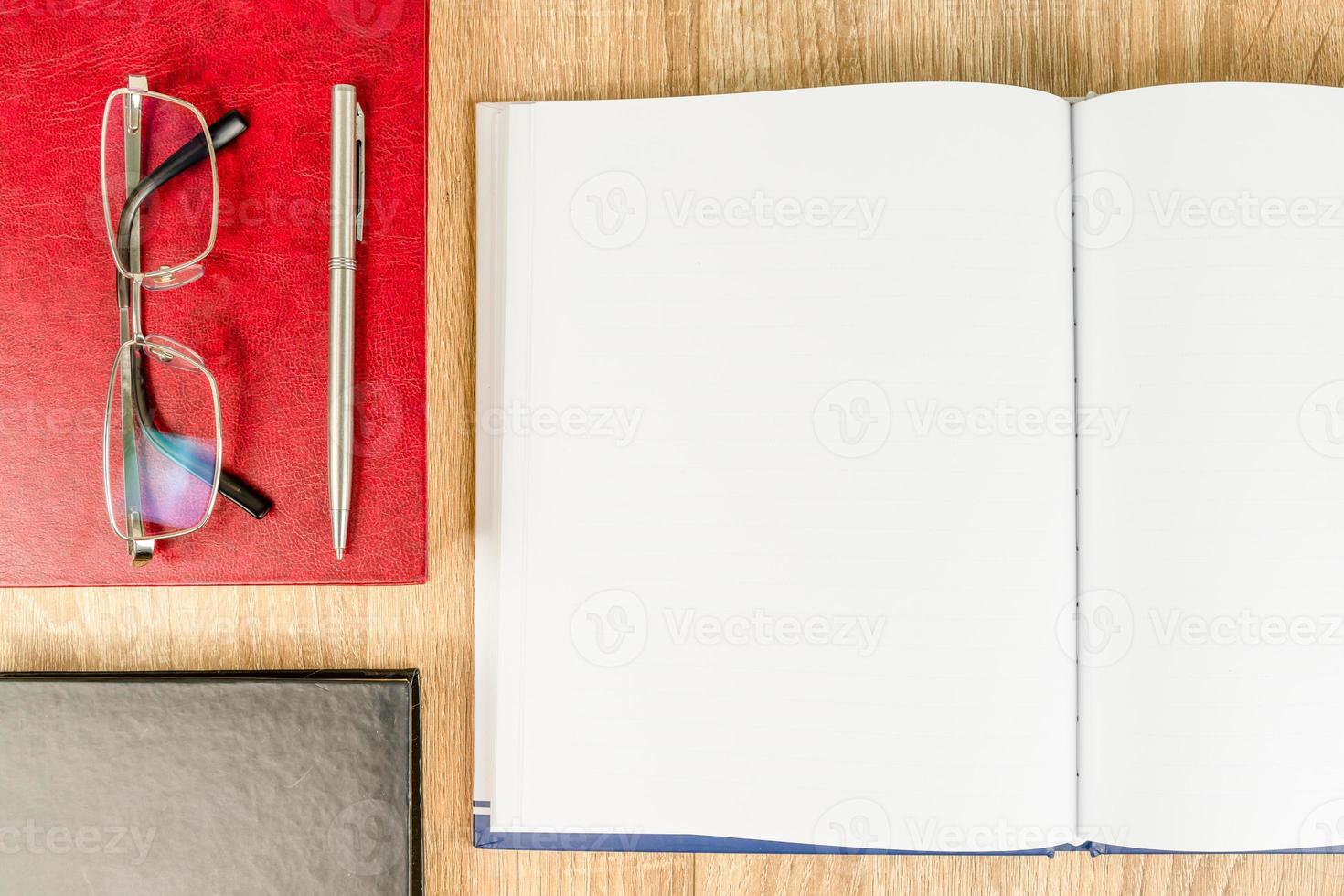 Top view empty blank notebook diary and eye glasses photo