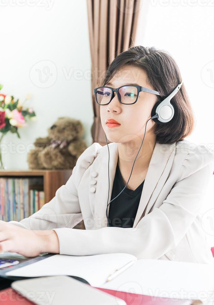 Teenage girl working on laptop in home office photo