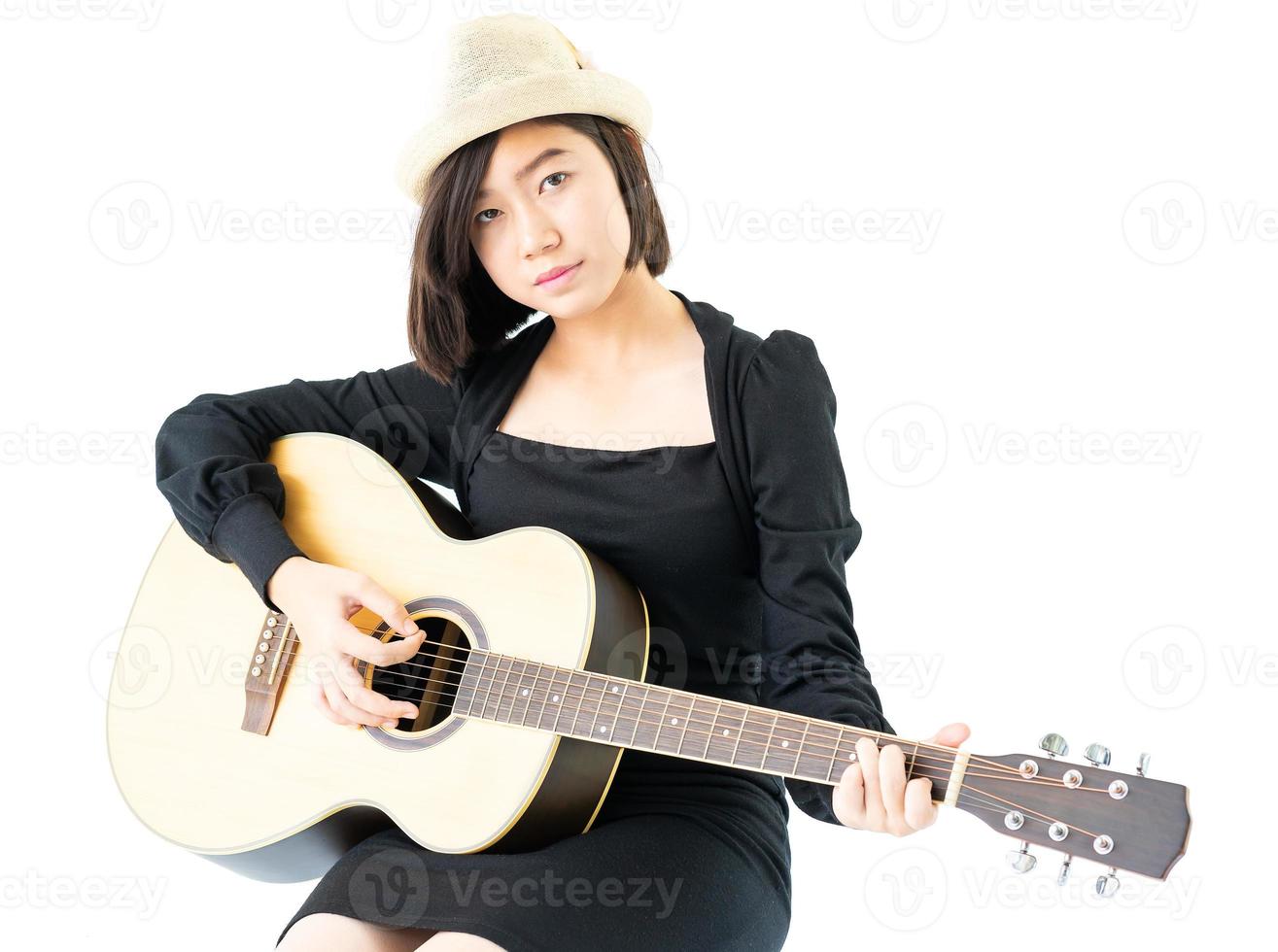 Woman sitting and playing guitar guitar folk song in her hand photo
