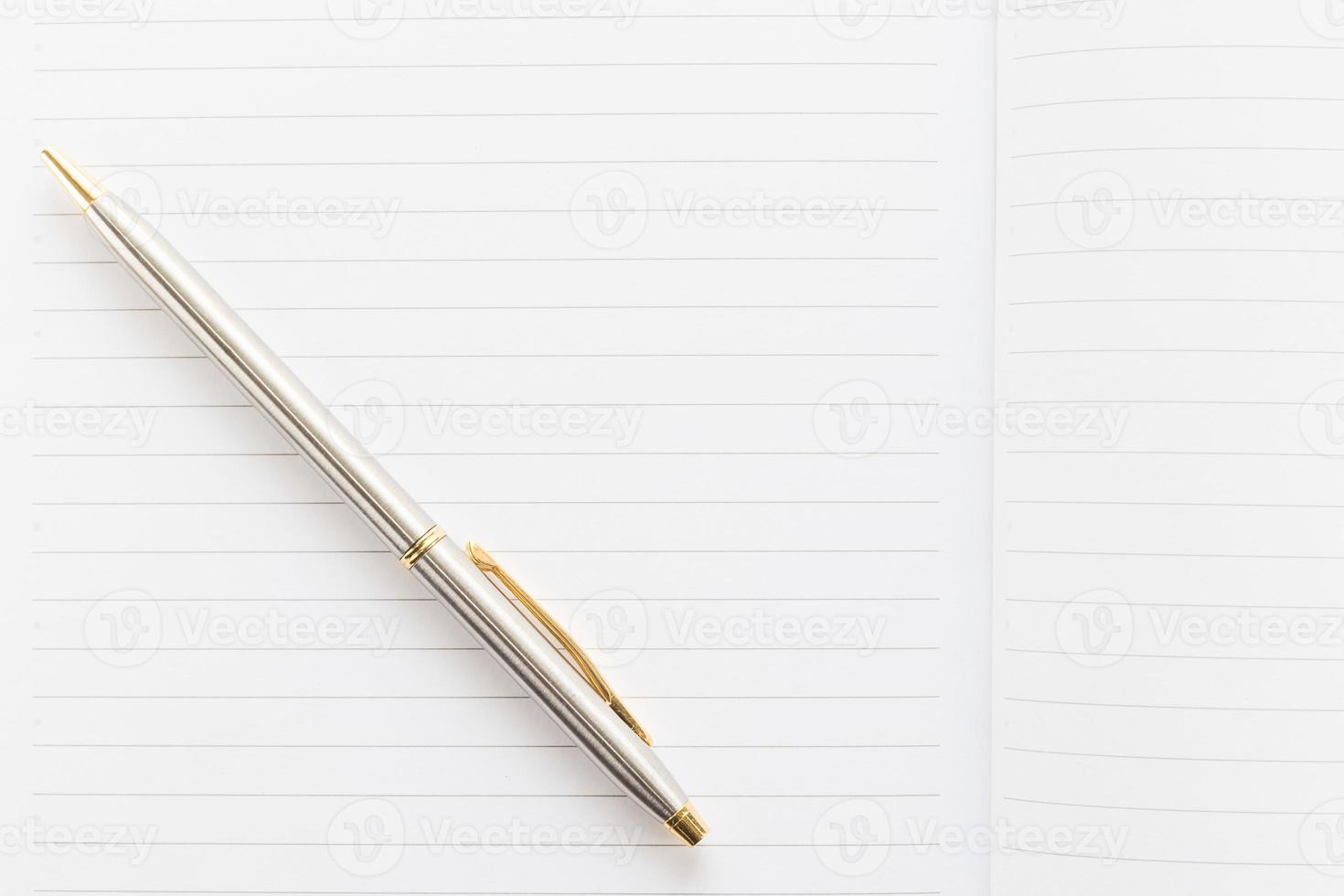 Pen and open notebook with blank page photo
