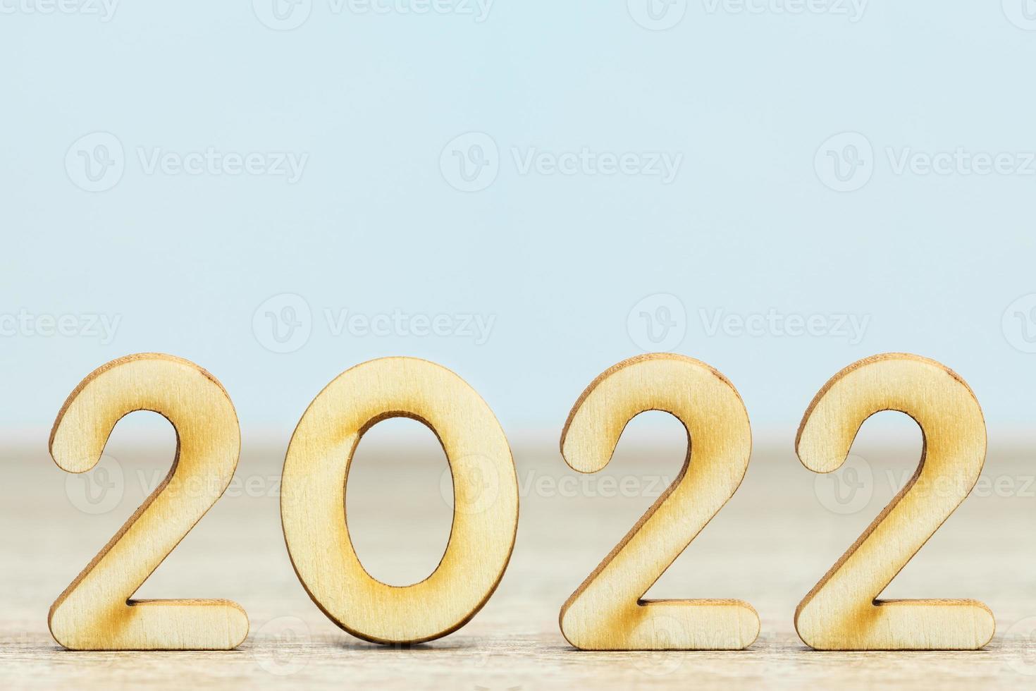 Wooden numeric new year 2022 on table photo