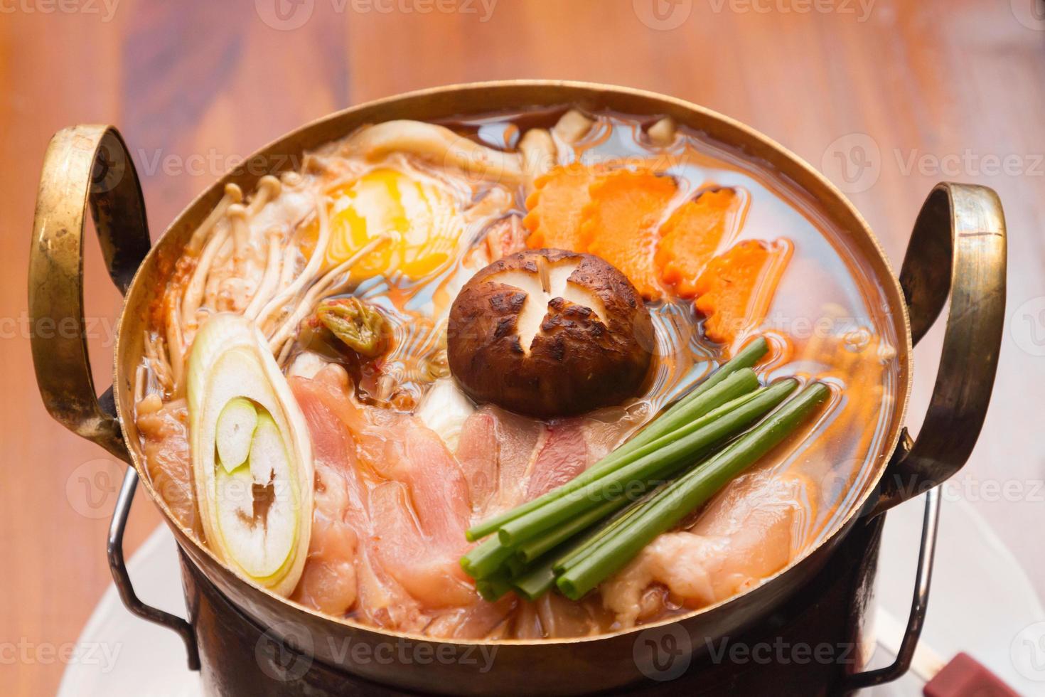 Japanese food. Sukiyaki. Meat and vegetables boiled in broth. photo