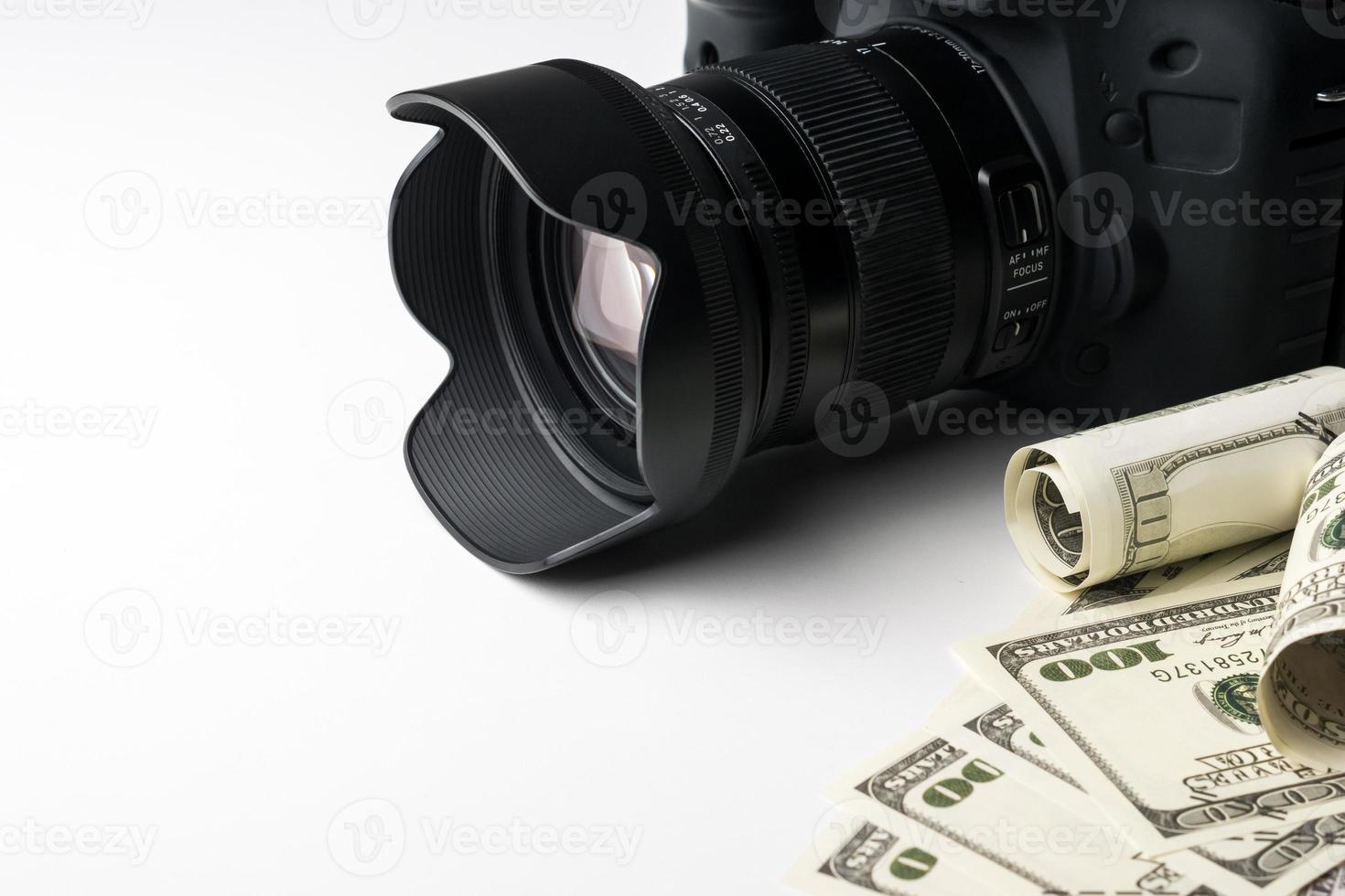 A black digital camera on banknotes with white background. photo