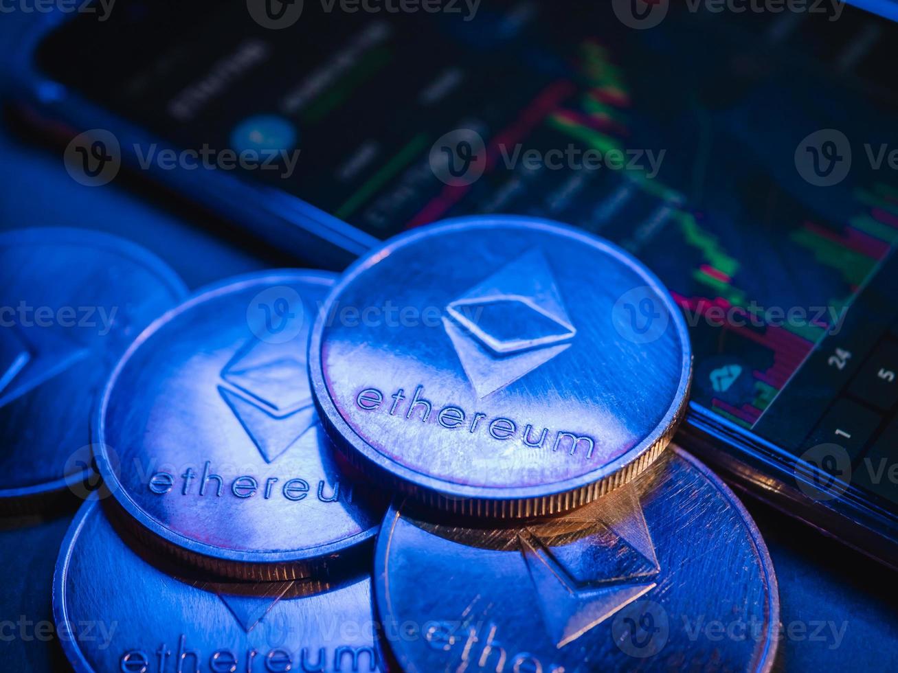 Ethereum coins with stock graph background. Digital currency concept. photo