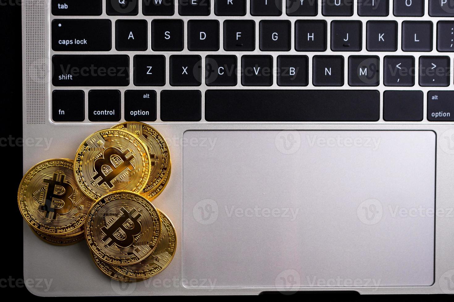 Golden coins with bitcoin symbol on computer. photo