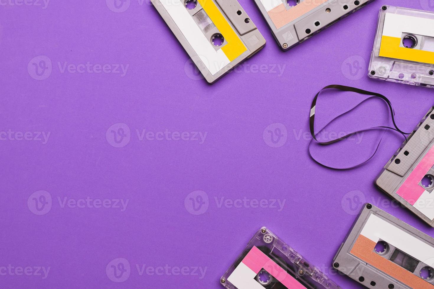 Collection of cassette tapes on purple background. Copy space fot text photo
