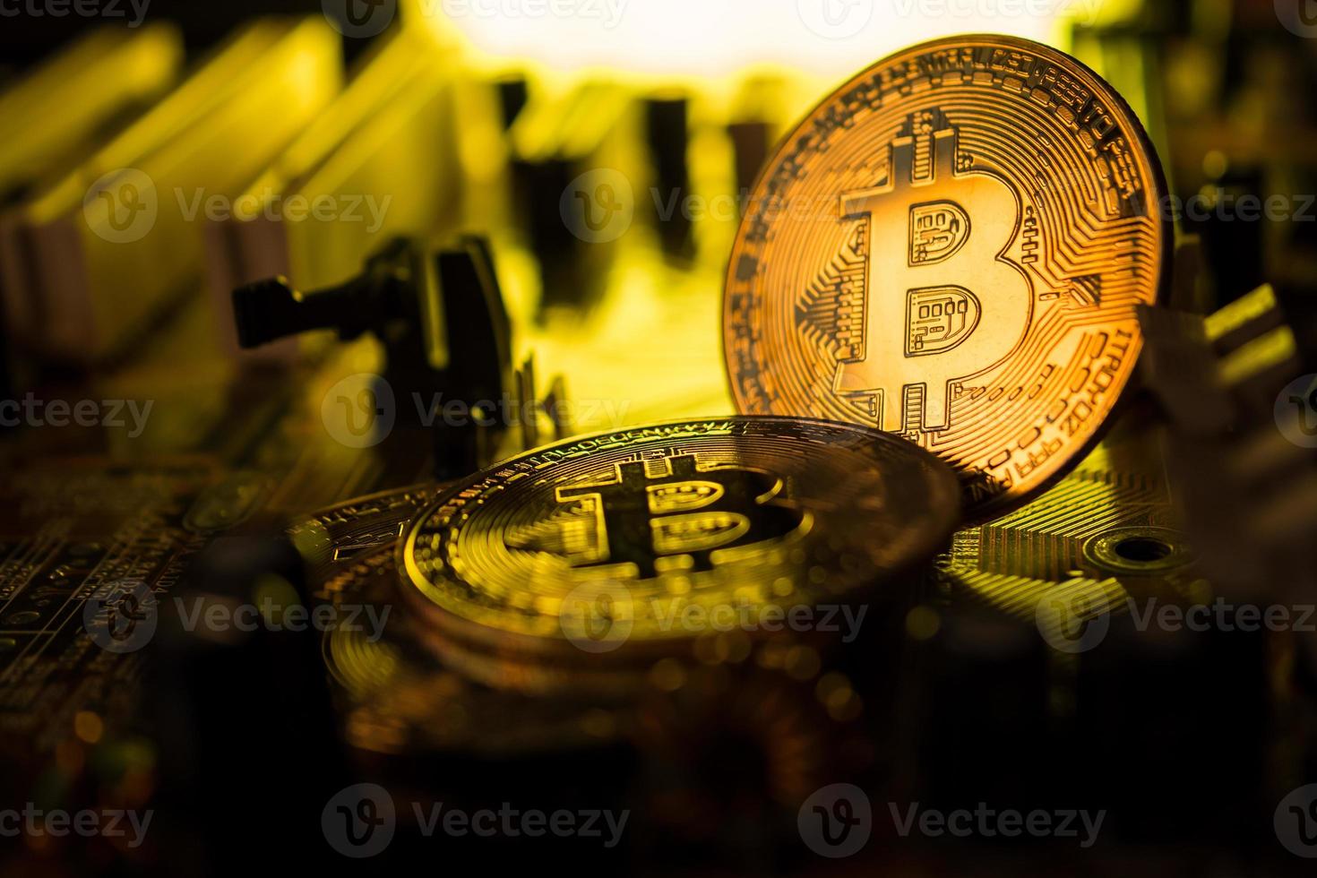 Golden coins with bitcoin symbol on a main board computer. photo