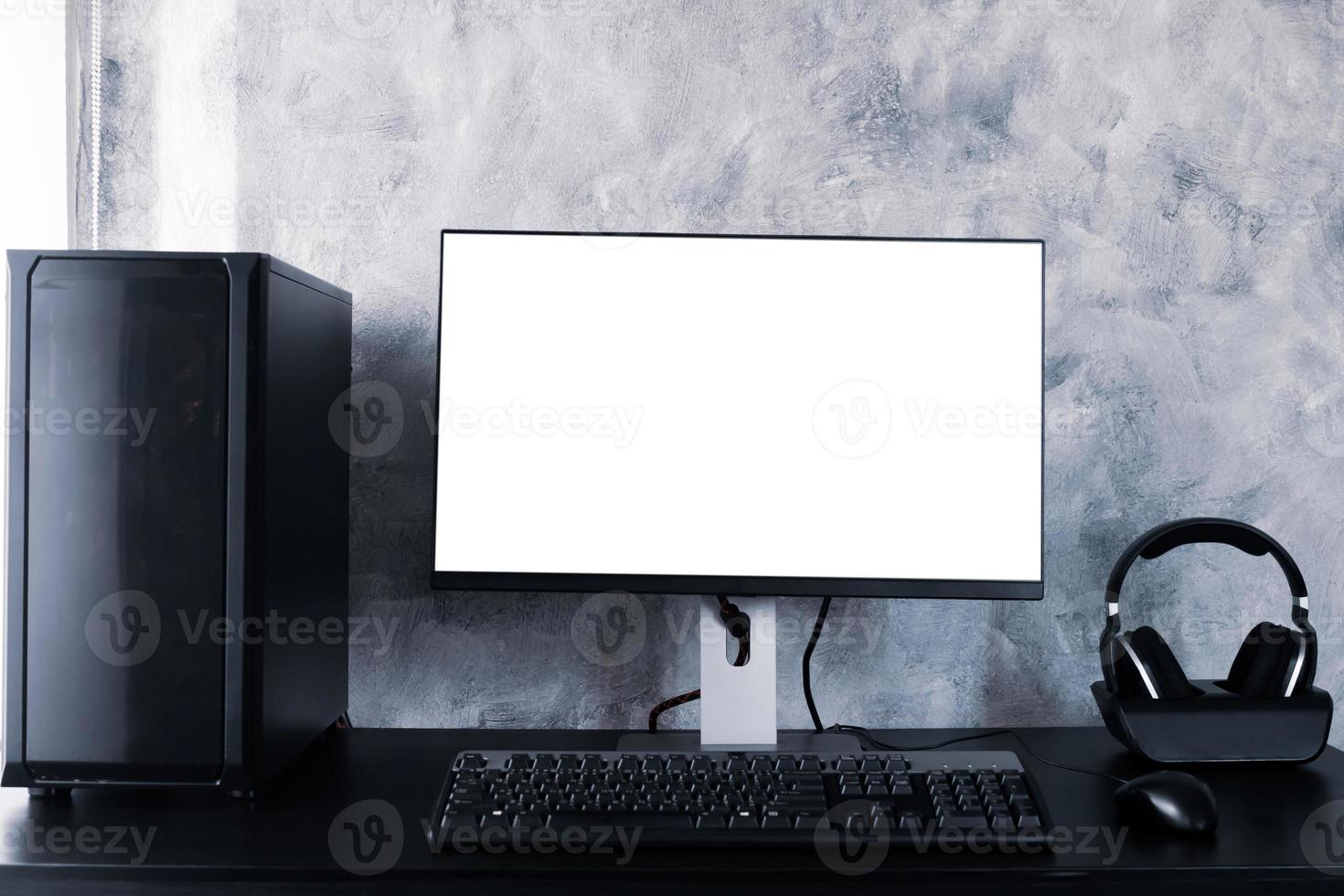 Black computer with white screen monitor on the desk. photo