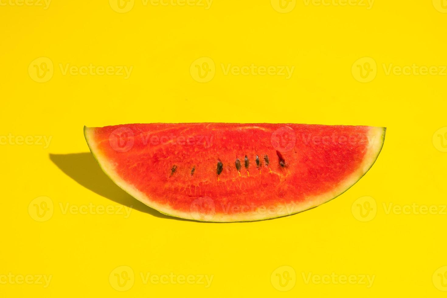 Fresh ripe watermelon slice on yellow background. photo