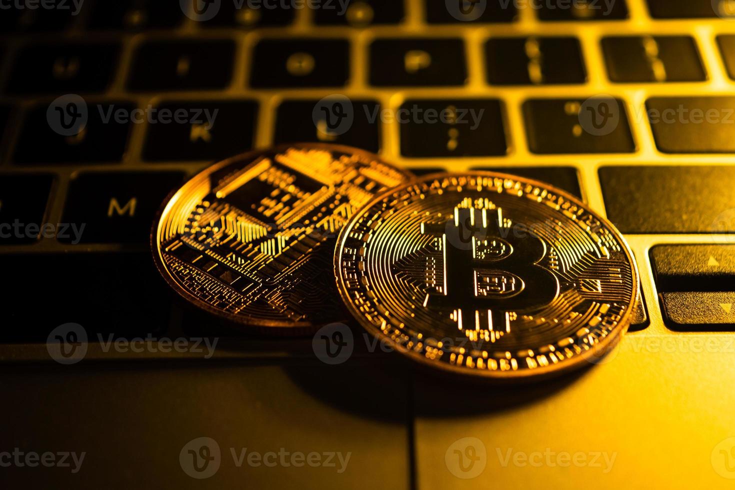Golden coins with bitcoin symbol on computer. photo