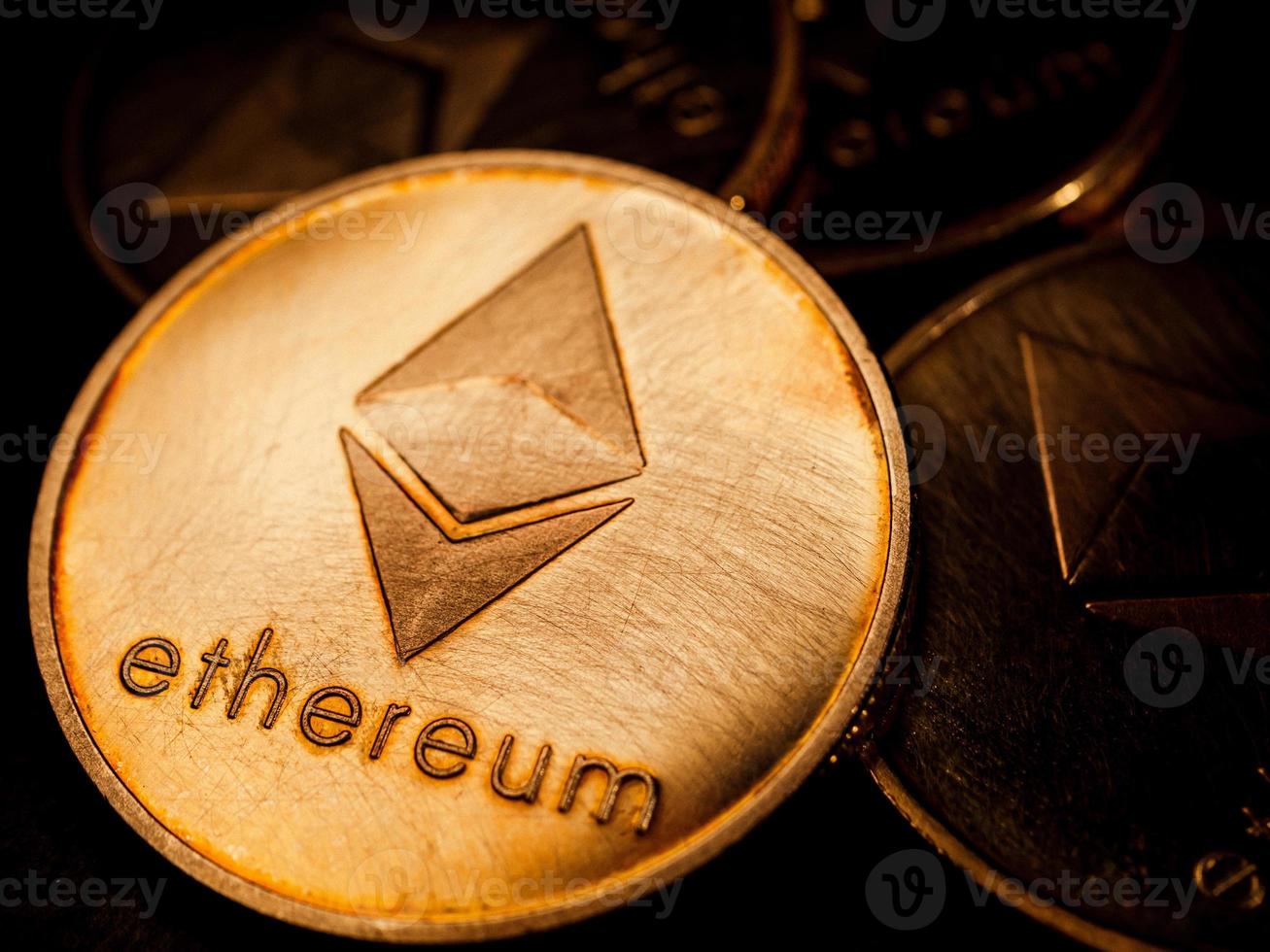 Close up of golden coins with ethereum symbol. Digital currency concept. photo
