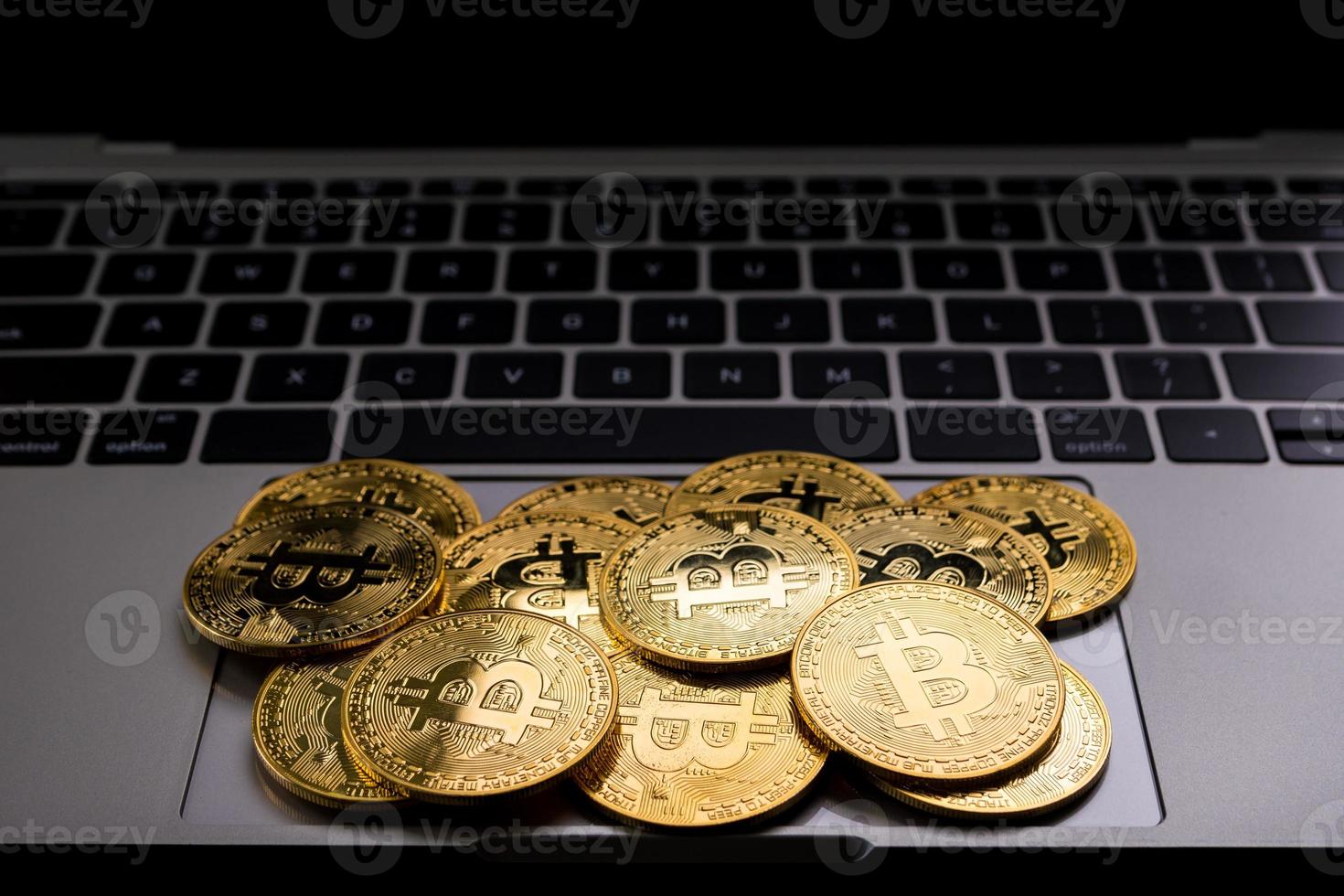 Golden coins with bitcoin symbol on computer. photo