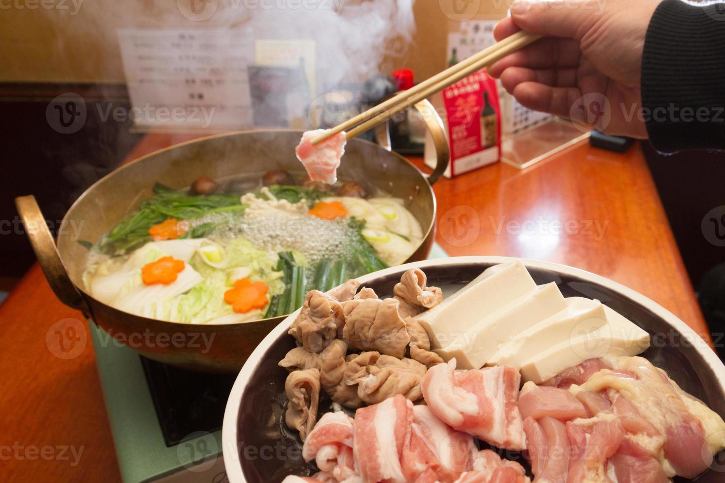 Japanese food. Sukiyaki. Meat and vegetables boiled in broth. photo