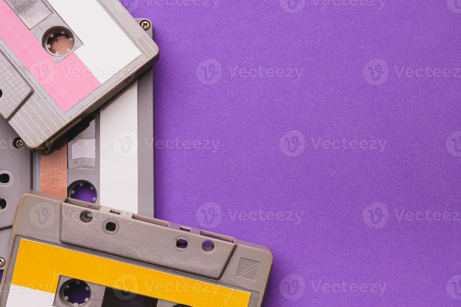 Collection of cassette tapes on purple background. Copy space fot text photo