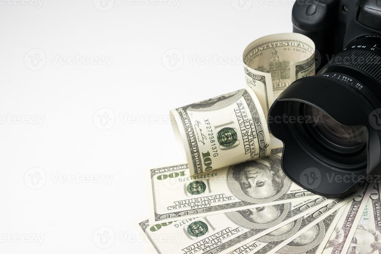 A black digital camera on banknotes with white background. photo