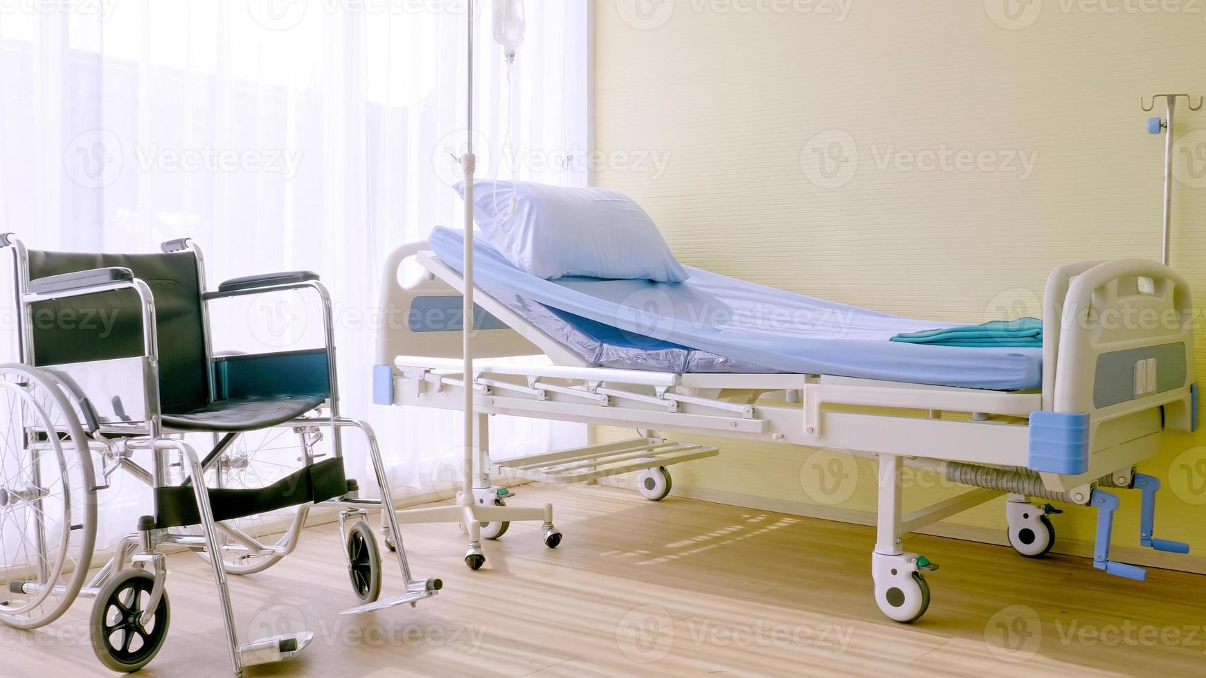 Hospital bed and wheelchair at hospital room. photo