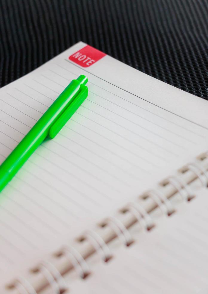notebook and pen on table photo