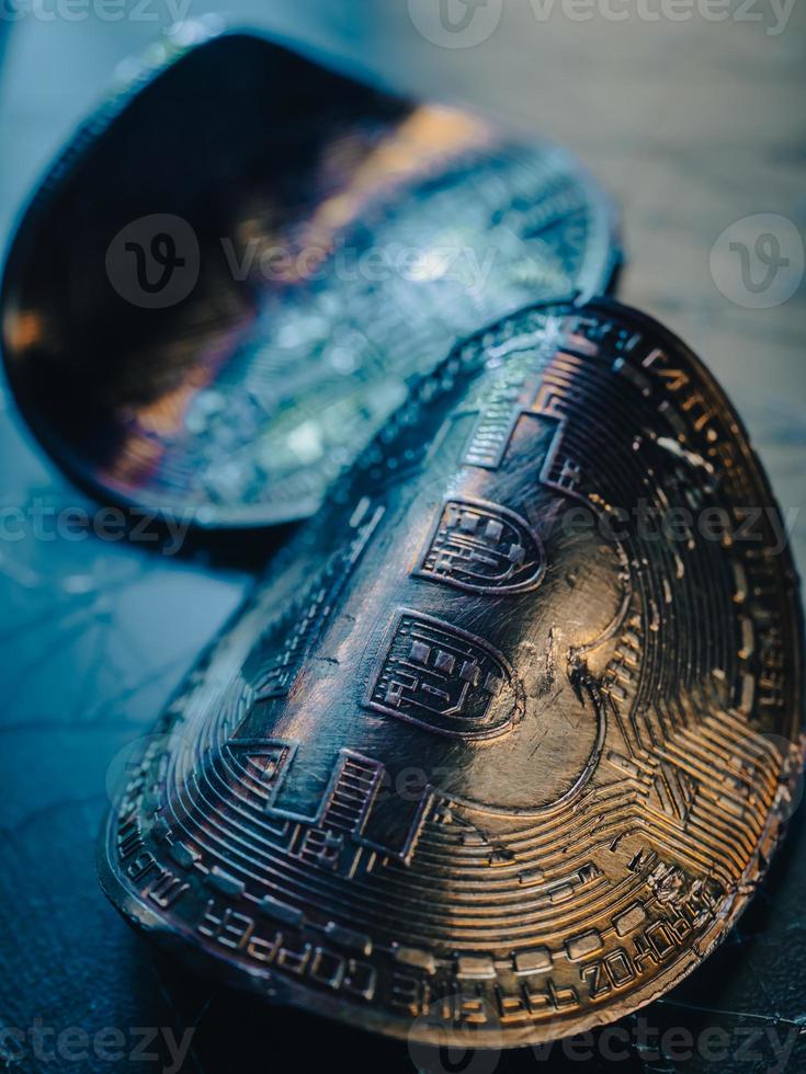 Twisted gold coins with bitcoin symbol. Concept of a cryptocurrency market crisis. photo