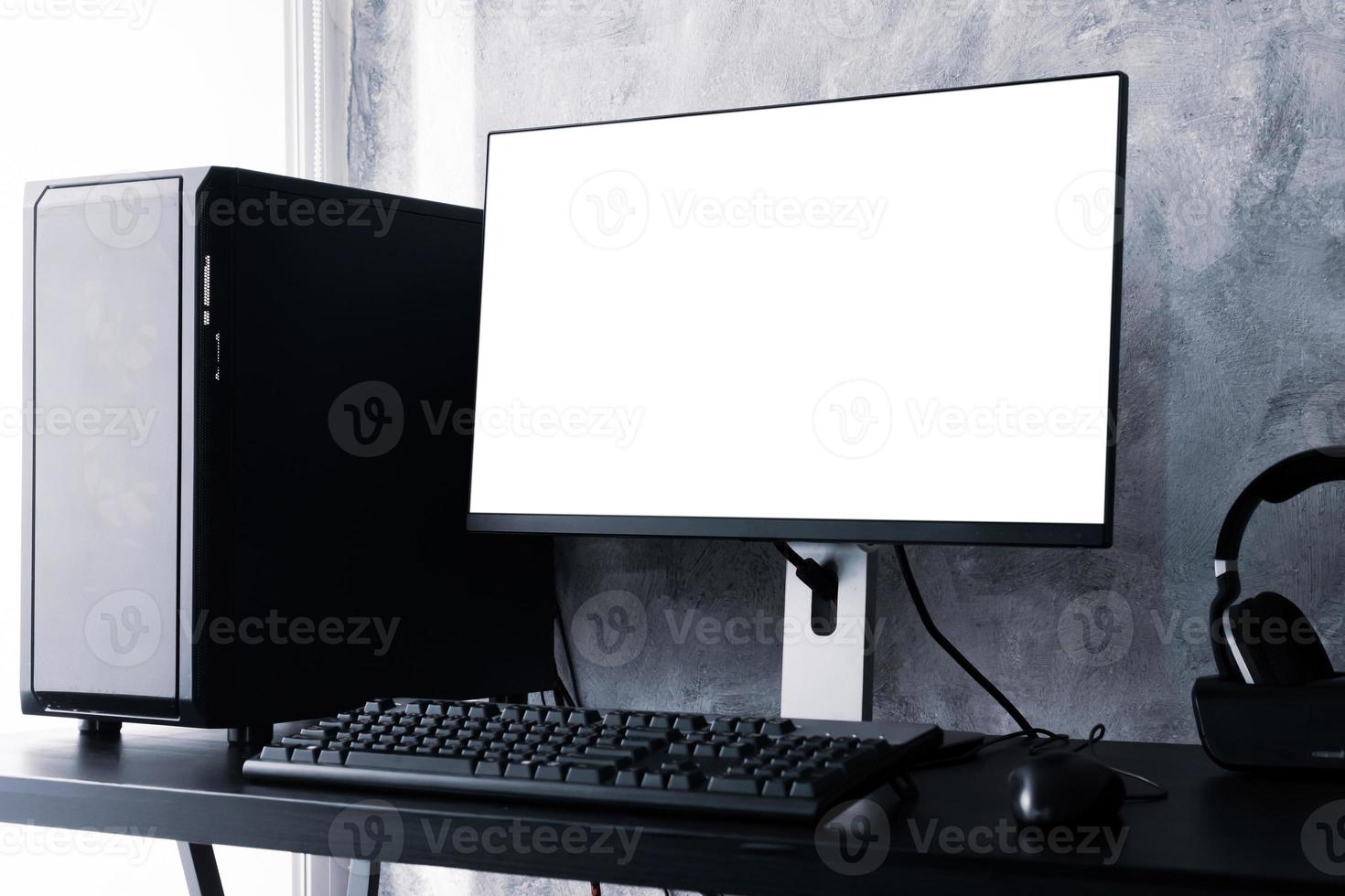 Black computer with white screen monitor on the desk. photo